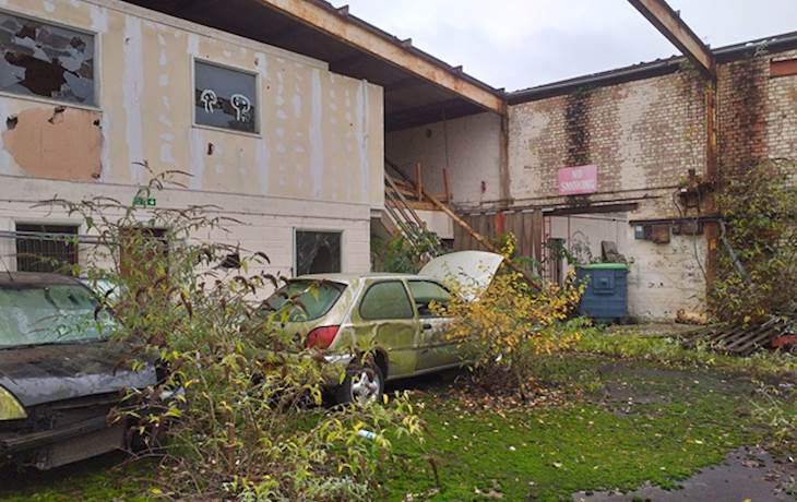 Outside Derelict Buildings With Abandonend Cars
